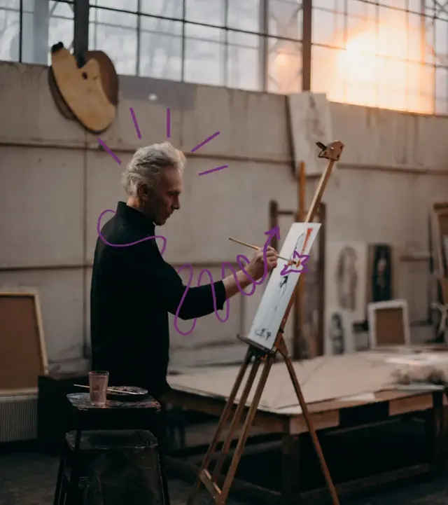 Peintre au travail devant son chevalet, dans un atelier